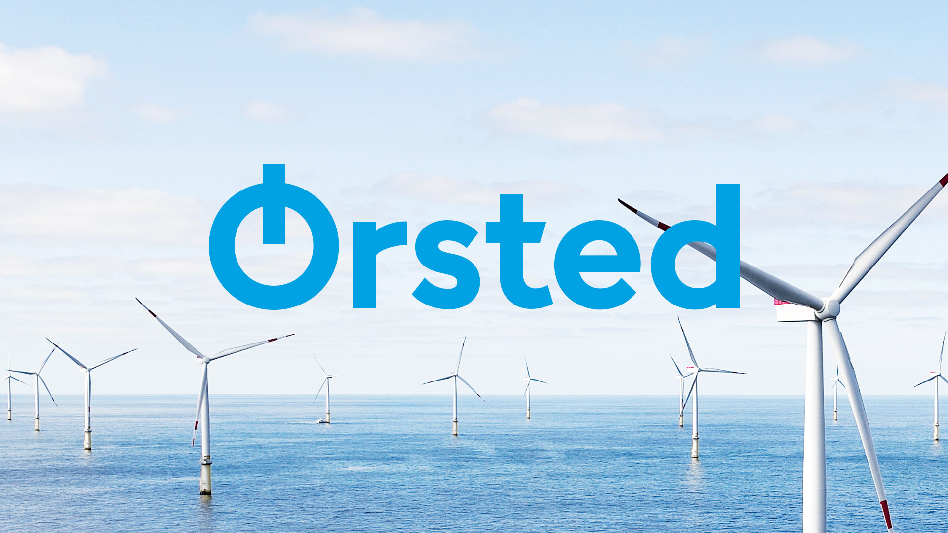 The new Ørsted logo over a field of wind turbines.