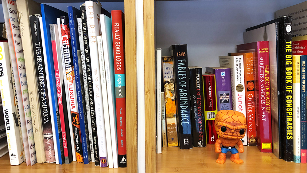 A row of branding and marketing strategy books on on Eric Johnson's bookshelf.