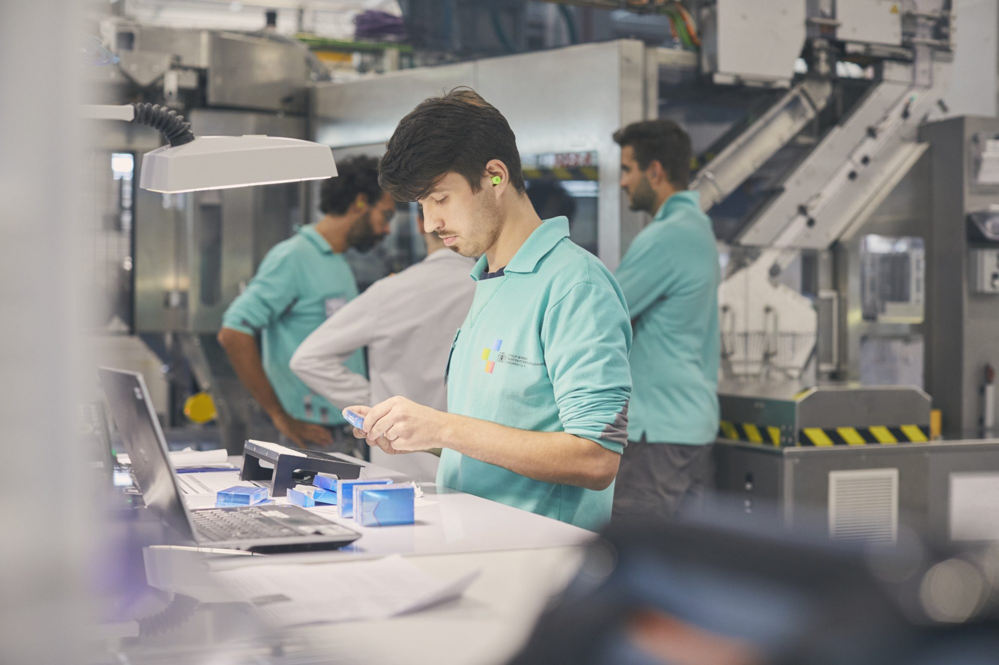 A PMI employee works in a factory.