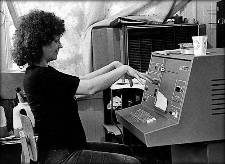 A woman works at a Compugraphic typesetter in 1975.