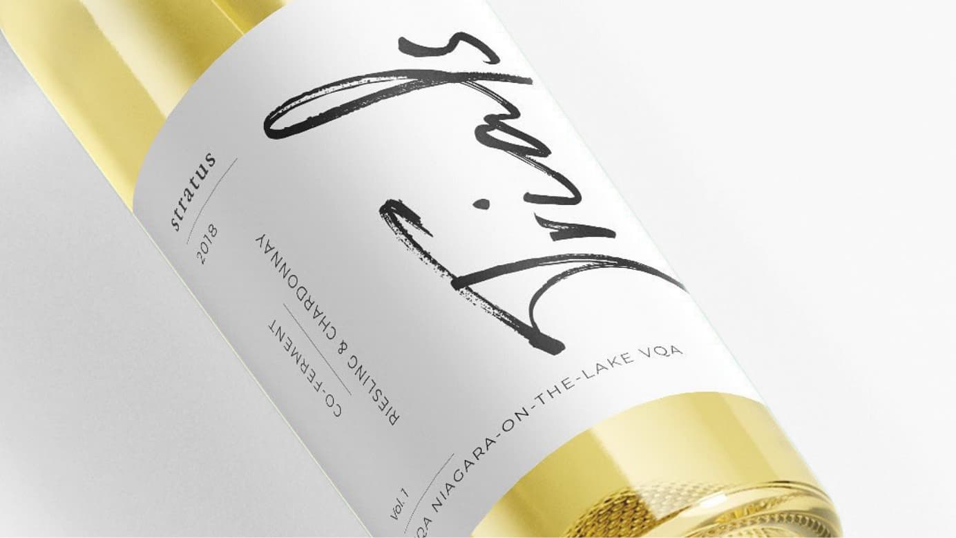 Close-up of a wine bottle label. The label text says: “Stratus 2018. Trials. Co-ferment Riesling and Chardonnay. Vol. 1. VQA Niagara-on-the-Lake VQA.”