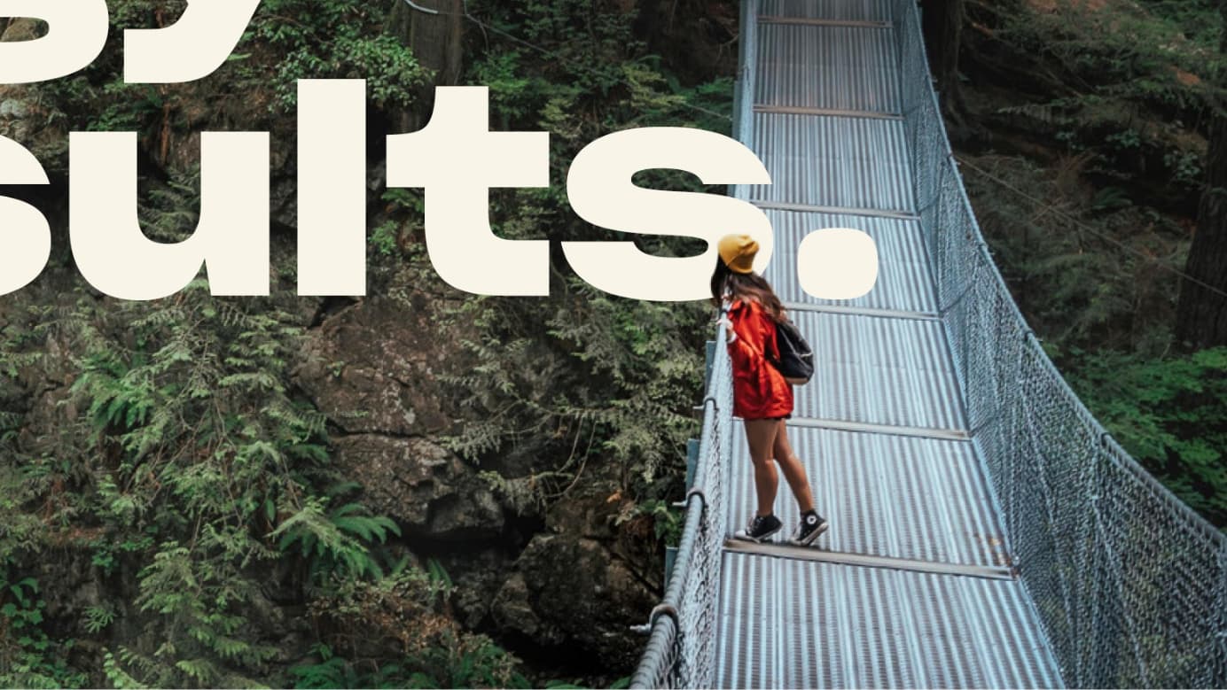 Close-up of a page from Vancity’s 2024 Annual Report, showing a person on a suspension bridge over a gorge.